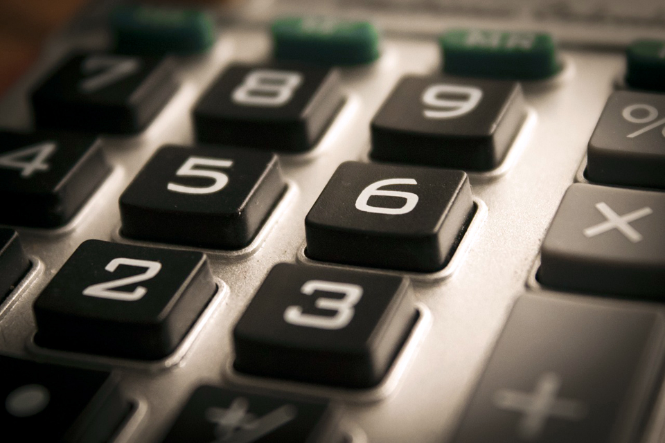 Calculator close up, focusing on number keypad.